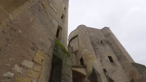 The-stone-walls-of-the-German's-Gate-castle-in-Metz,-France-stretch-to-the-sky-in-this-upward-tilting-shot