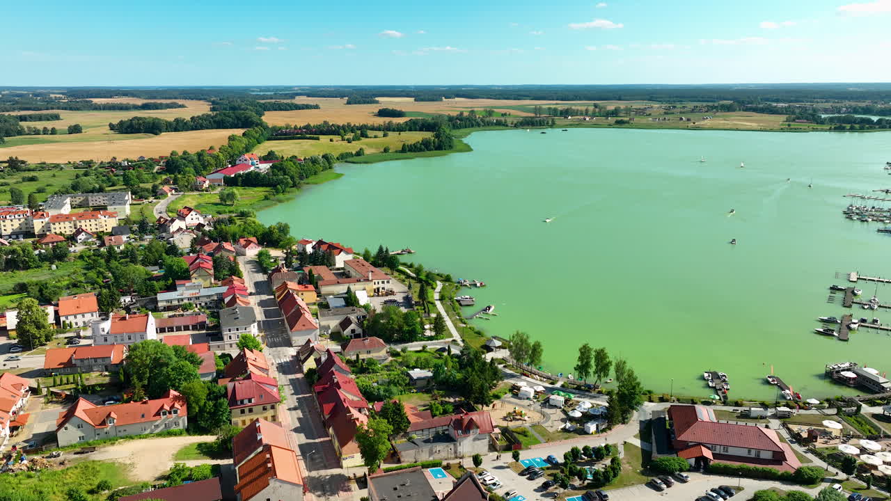 Aerial View of a Lakeside Town and Green Lake