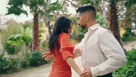 young professionals dancing energetic in park. couple dancers enjoy latino dance