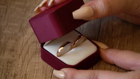 closeup wedding rings on in a box when the woman closes the box