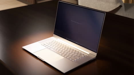 silver laptop on a dark wooden table