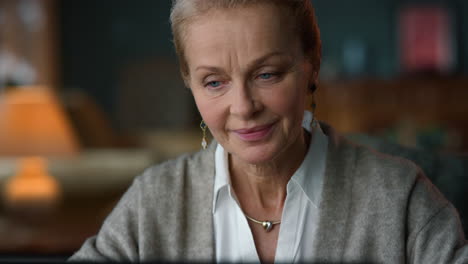 Senior-woman-looking-laptop-computer-in-home-interior.-Old-lady-portrait