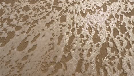 "stress" word is written on the beach sand and erased with a wave, a concept video of relaxation and stress relief