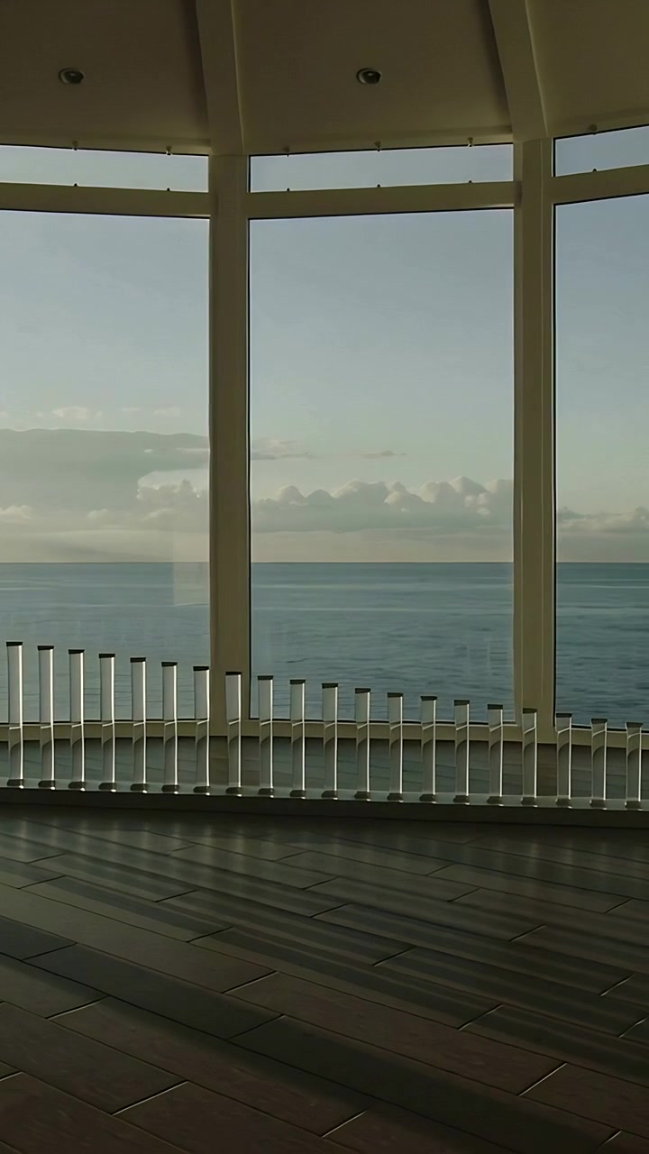 Vertical video: Panning camera right from left past curved windows in shore lounge