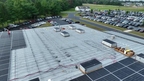 solar panels sitting on industrial roof waiting for installation on metal tracks