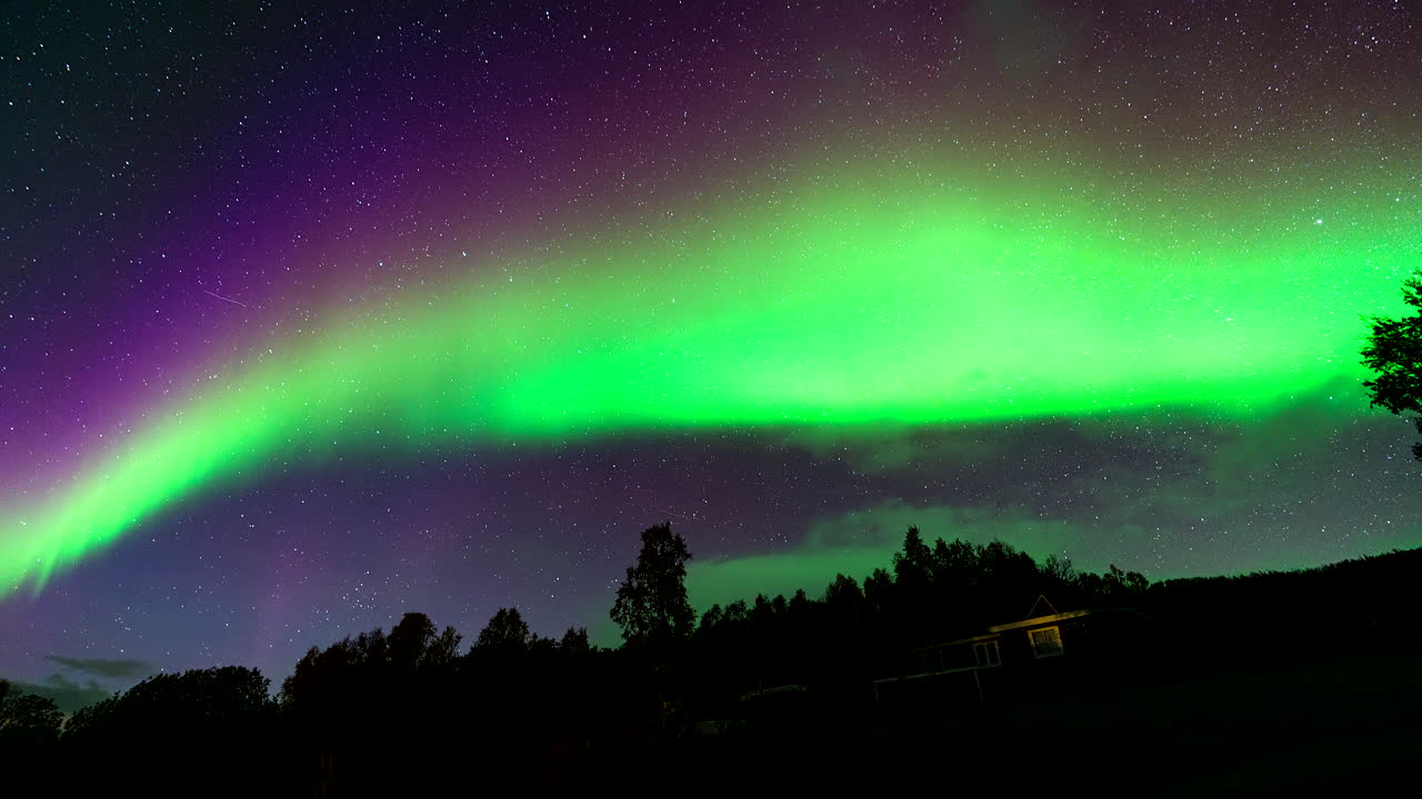 Stunning Aurora Borealis over a Cabin in the Woods