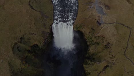 A-drone-tilts-over-the-Skógafoss-Waterfall-in-Iceland-in-an-establishing-shot