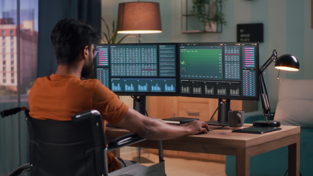 Man in Wheelchair Trading Stocks at Home