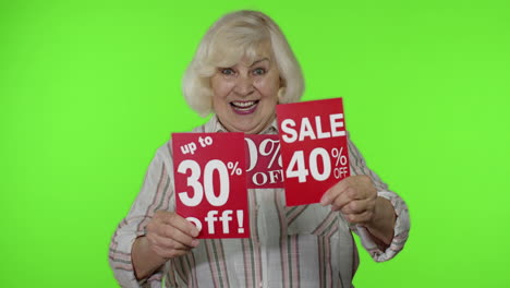 Senior-woman-showing-sale-percent-discounts-advertisement-inscriptions-banners.-Black-Friday