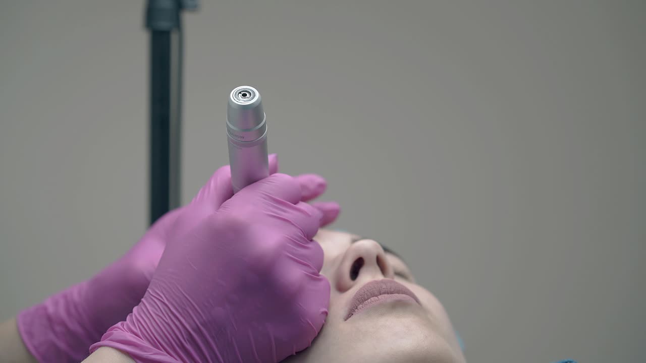 beauty salon cosmetician hands hold client forehead slow