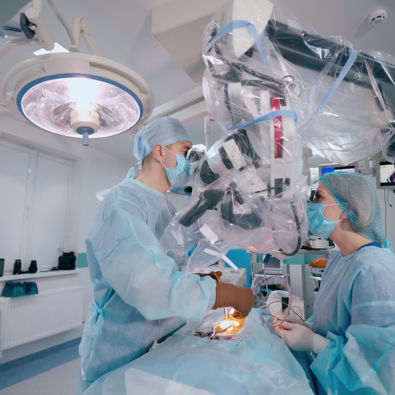 Process of surgery in the modern operating room. Doctors perform an operation using innovative equipment. Operation on back.