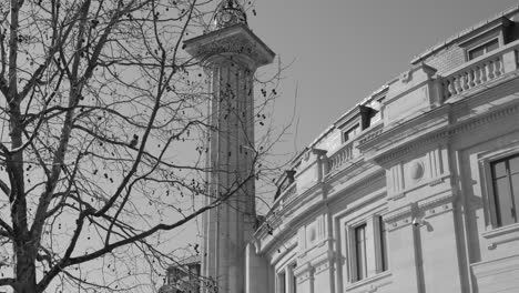 black and white shot of bourse de commerce, commodities exchange building in paris, france on a sunny day. tilt down.