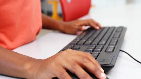 schoolboy using computer in classroom