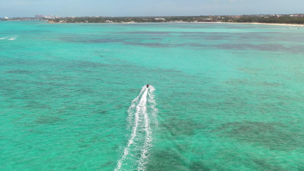Jet Ski in Emerald Tropical Water. Drone Aerial of Scooter and Bahamas Coastline