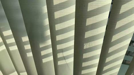 ray of sun lighting through transparent curtain on window at evening summer time