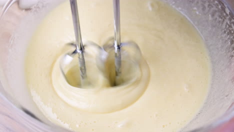 chef mixing ingredients with electric mixer in a bowl