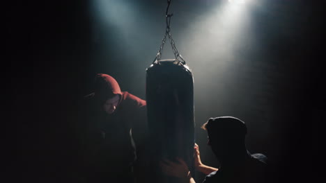 boxer and partner train in the gym