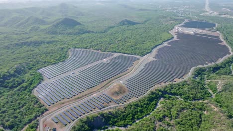 swathes of lush jungle cleared for solar farm with photovoltaic system, aerial