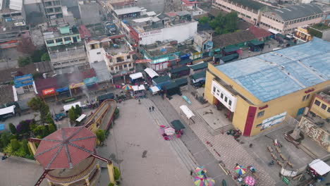 slow aerial rotation over the square in san juan ostuncalco show the beginnings of the street market