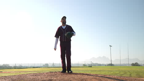 pitching on baseball field, man in uniform preparing for game