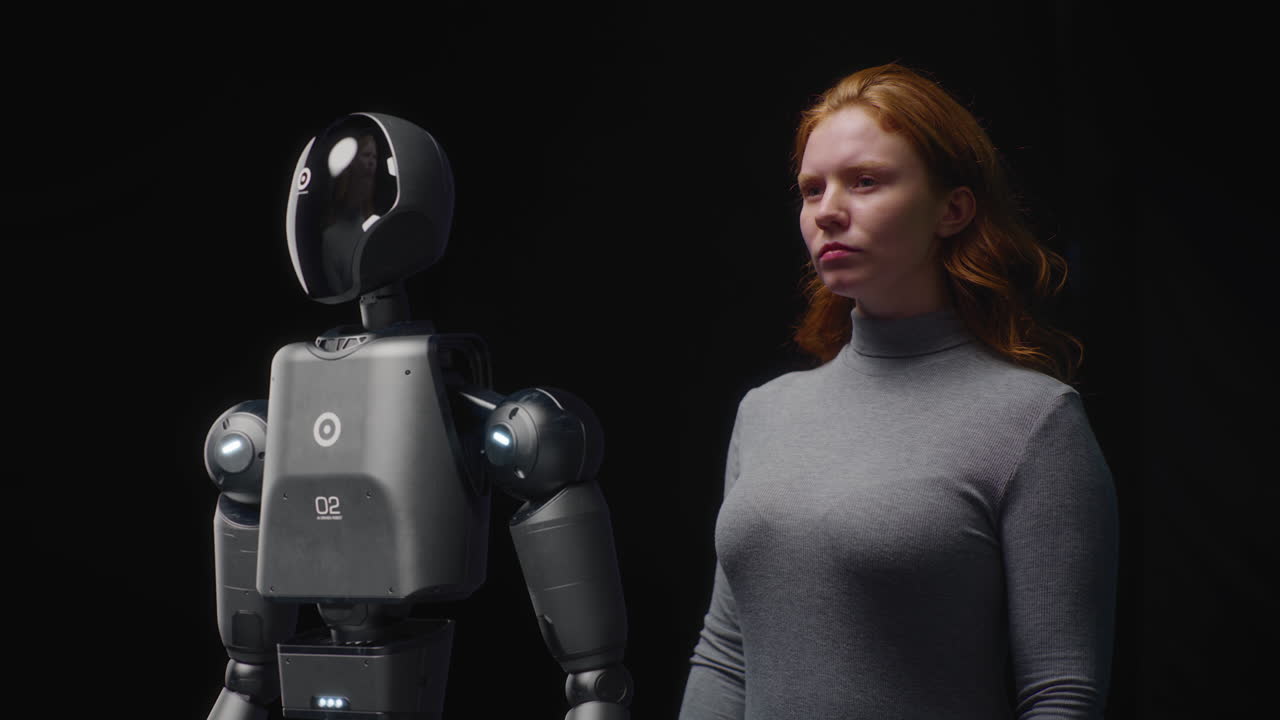 people and Robots Concept Visualization of Young Woman Standing with Advanced Humanoid Robot Vfx Animation of Futuristic People and Robots Concept Visualization of Young Woman Standing with Advanced Humanoid Robot Collaboration and Connection between Humanity and Artificial Intelligence