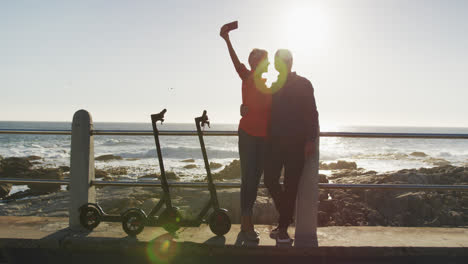 Senior-couple-taking-picture-alongside-beach