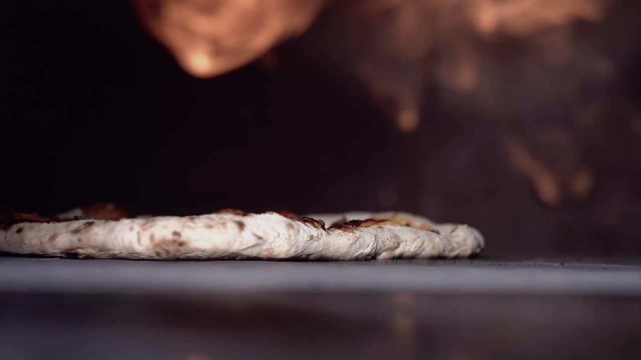 420 frames super slow motion pizza in a oven with flames