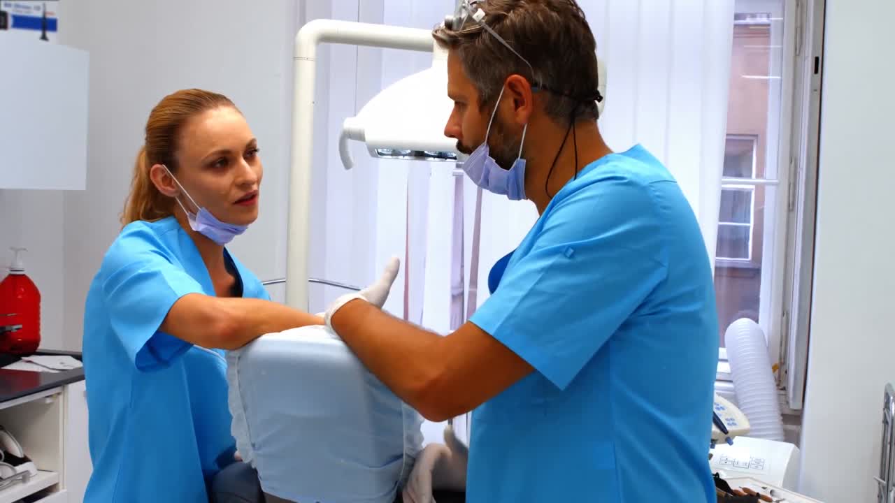 Dentists interacting with each other at dental clinic