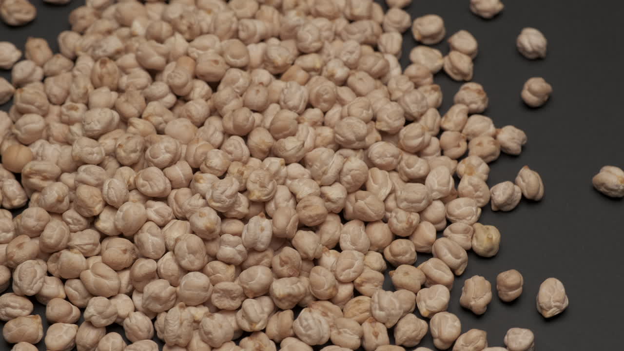 Dry chickpeas legumes uncooked rotating, Mediterranean diet healthy nutrition vegetarian or vegan