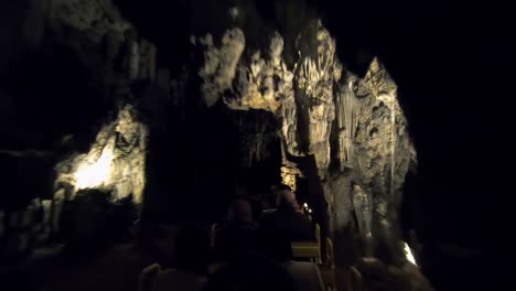 people travel by entertainment train in postojna cave