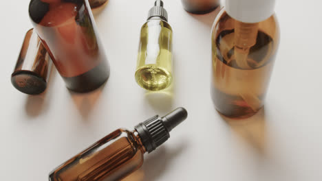 High-angle-view-of-glass-bottles-with-copy-space-on-white-background