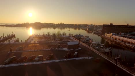 aerial drone shot flying amongst seagulls towards golden sunrise over severn river and chesapeake bay