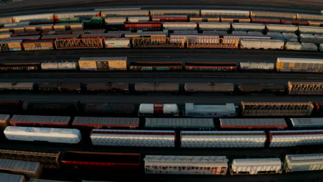 Aerial-slider-shot-over-freight-train-arriving-at-a-train-yard