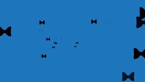 Animation-of-bow-ties-floating-over-blue-background