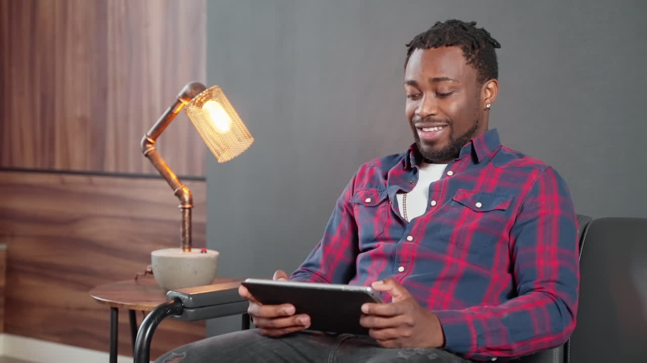Man Using Tablet in Armchair