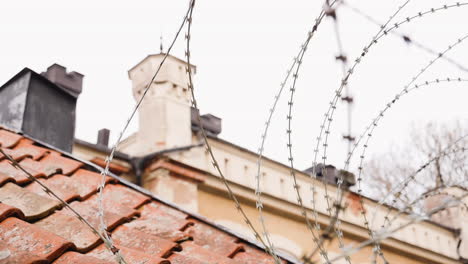 barbwire or nato-fence shielding off a wall