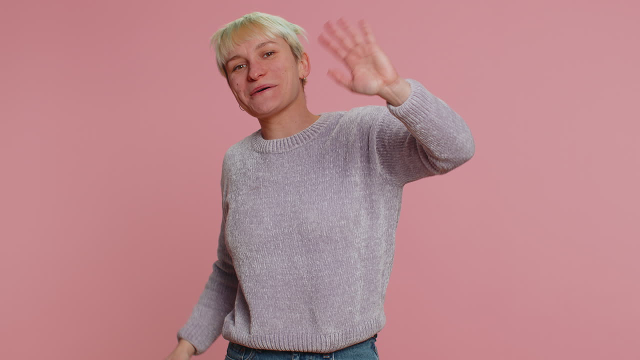 Woman showing inviting gesture with hands, ask to join, beckoning to coming, gesturing hello goodbye