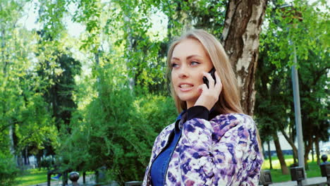 attractive woman walking in the city enjoys a smartphone prores 422 10 bit