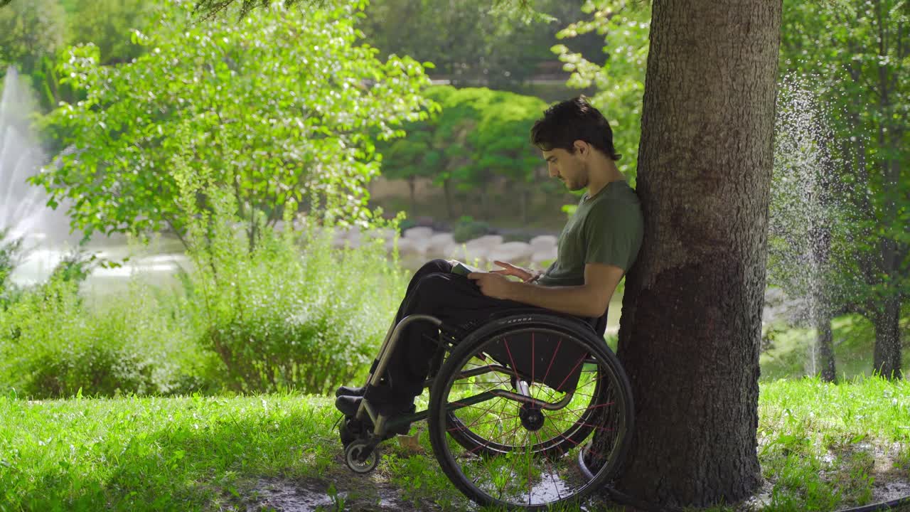 Adventurous physically disabled teenager reading a book outdoors.
