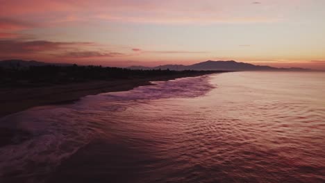 Aerial-low-angle-dolly-in-near-romantic-beach-in-Mexico-in-the-evening