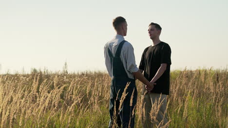 men holding hands outdoors