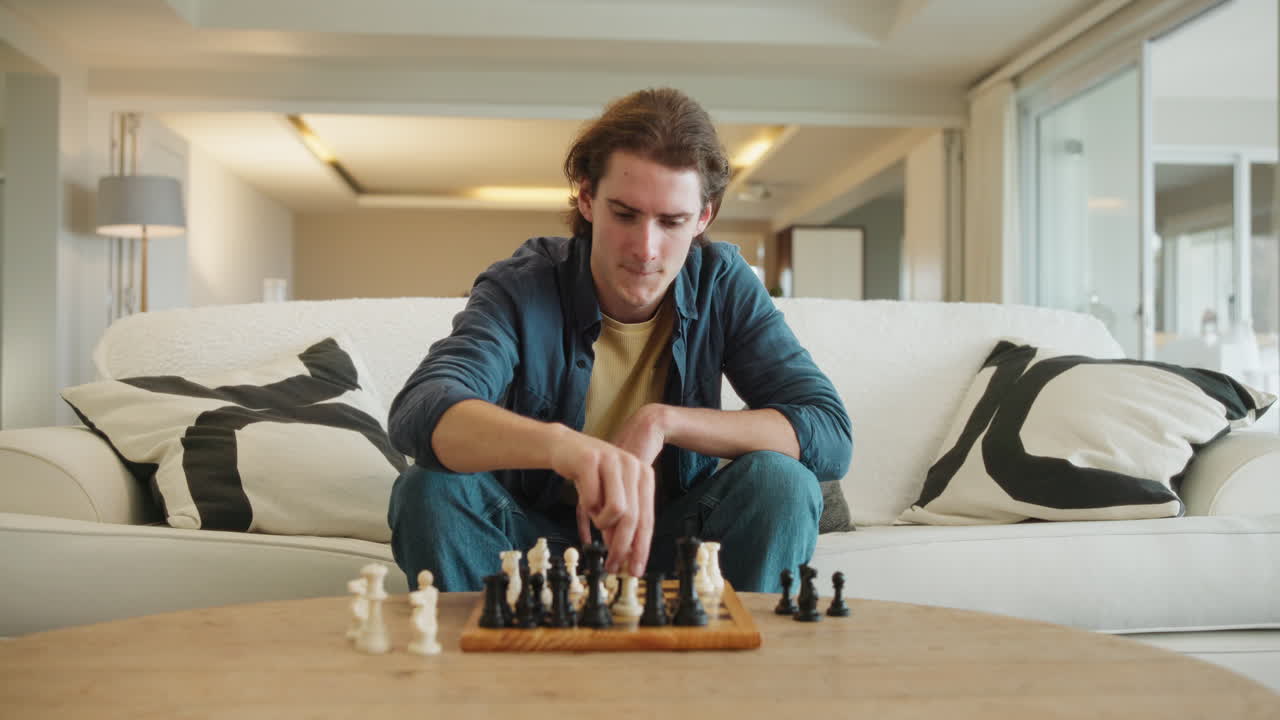 Man playing chess in living room