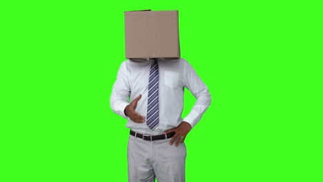 Businessman-with-box-over-head-shaking-hand