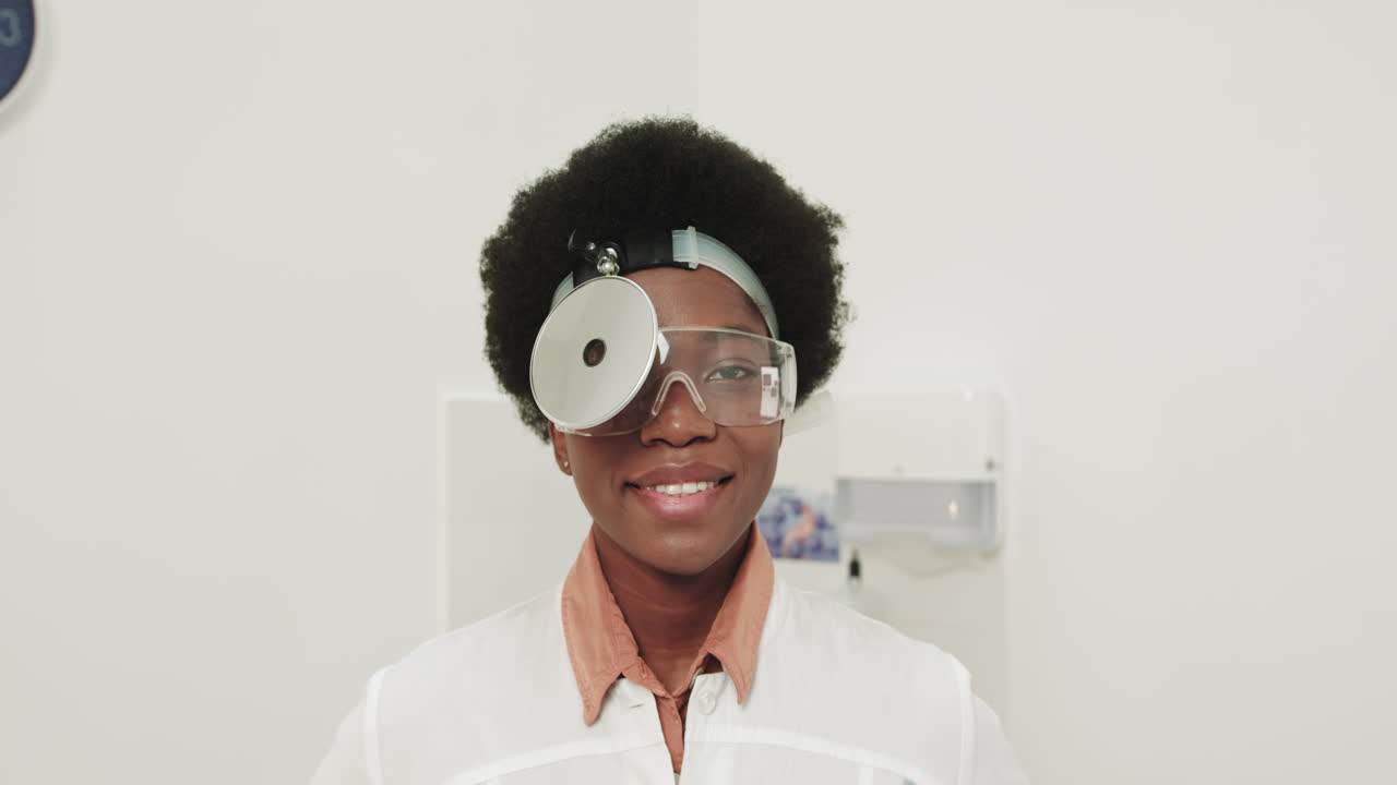 Close up of african american happy beautiful woman physician smiling to camera in clinic portrait of