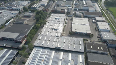 aerial of industrial rooftops filled with solar panels
