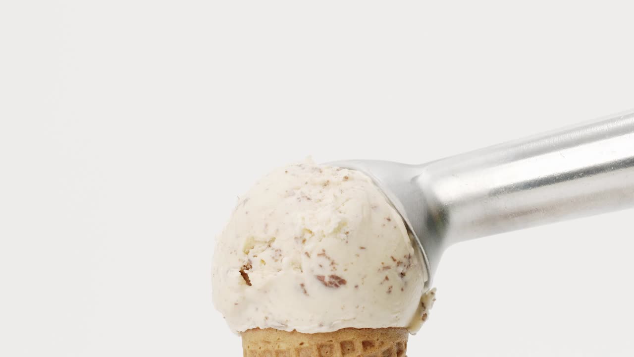 Hands scoop Ice cream Chocolate Chip in waffle cone isolated on white background.