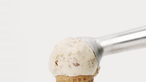 hands scoop ice cream chocolate chip in waffle cone isolated on white background.