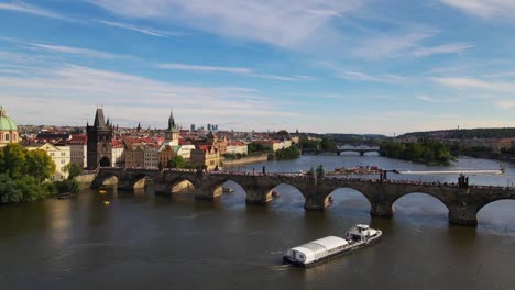 aerial footage of prague's iconic charles bridge spanning the vltava river, capturing the historic architecture and scenic beauty of this renowned european landmark.
