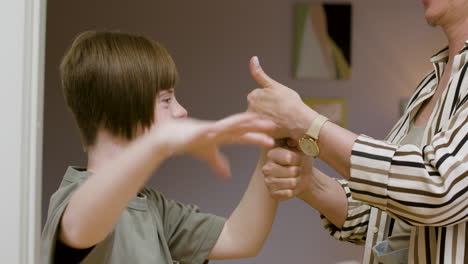 Cheerful-girl-having-fun-with-her-mom-at-home