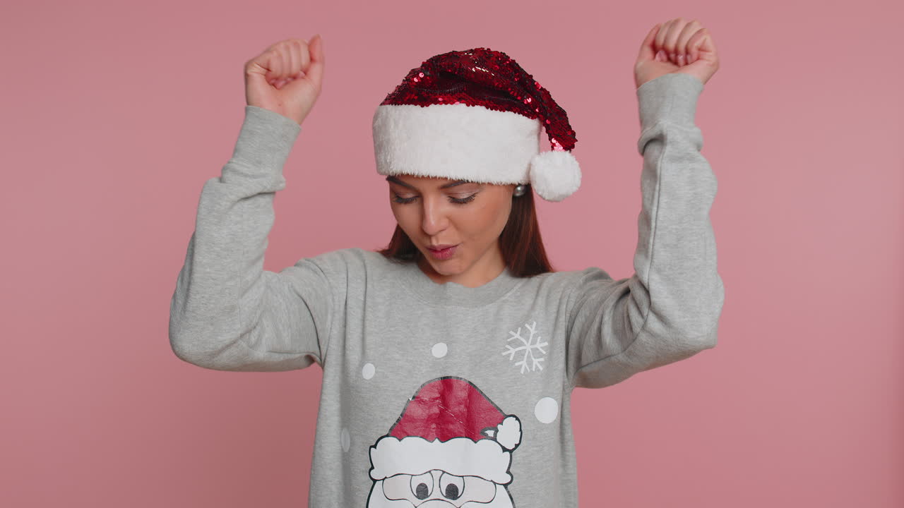 mujer de navidad gritando, levantando los puños en gesto lo hice, celebrando el éxito, ganando la lotería